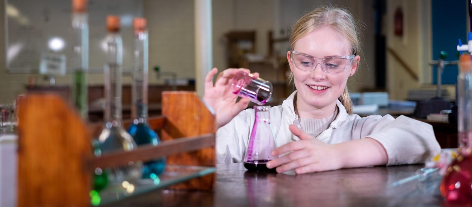 a girl pouring a liquid