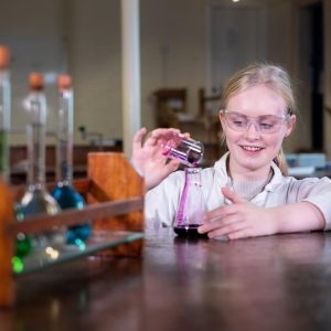 a girl pouring a liquid