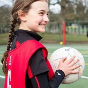 school girls playing netball