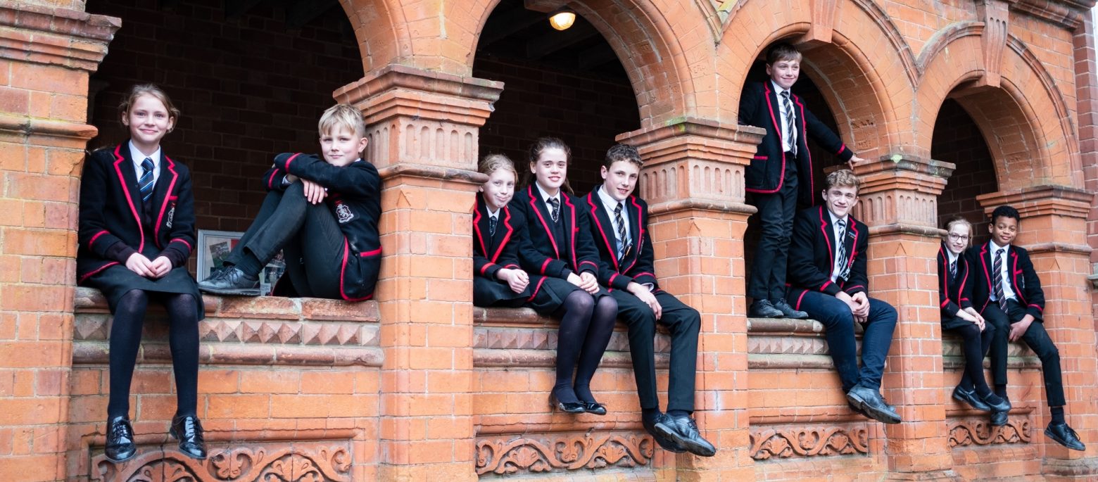 children sitting on a wall