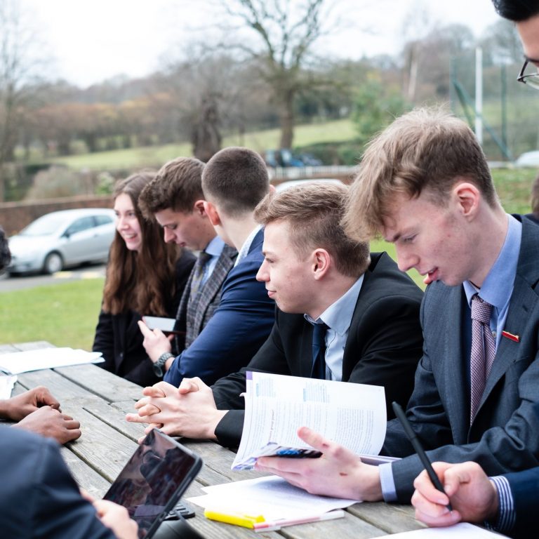 students from a sixth form in lucton working outside