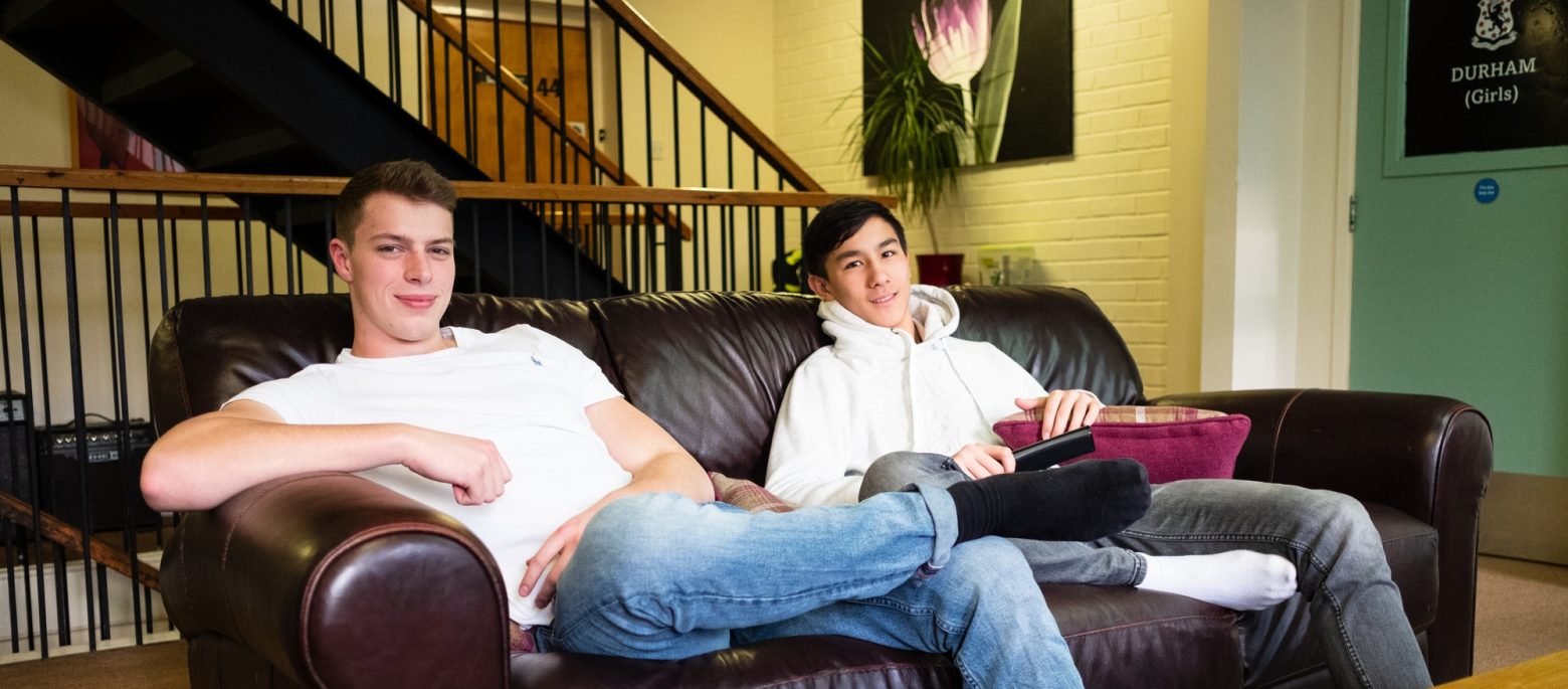 2 school boys sat on the sofa in our boarding facilities