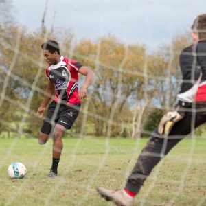 A boy is about to kick a football towards the goal