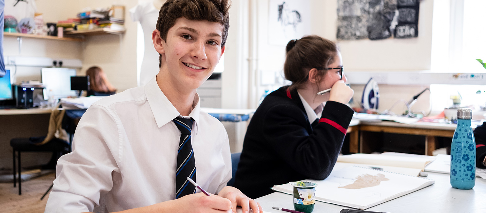 children from a prep school in lucton with pens in their hands