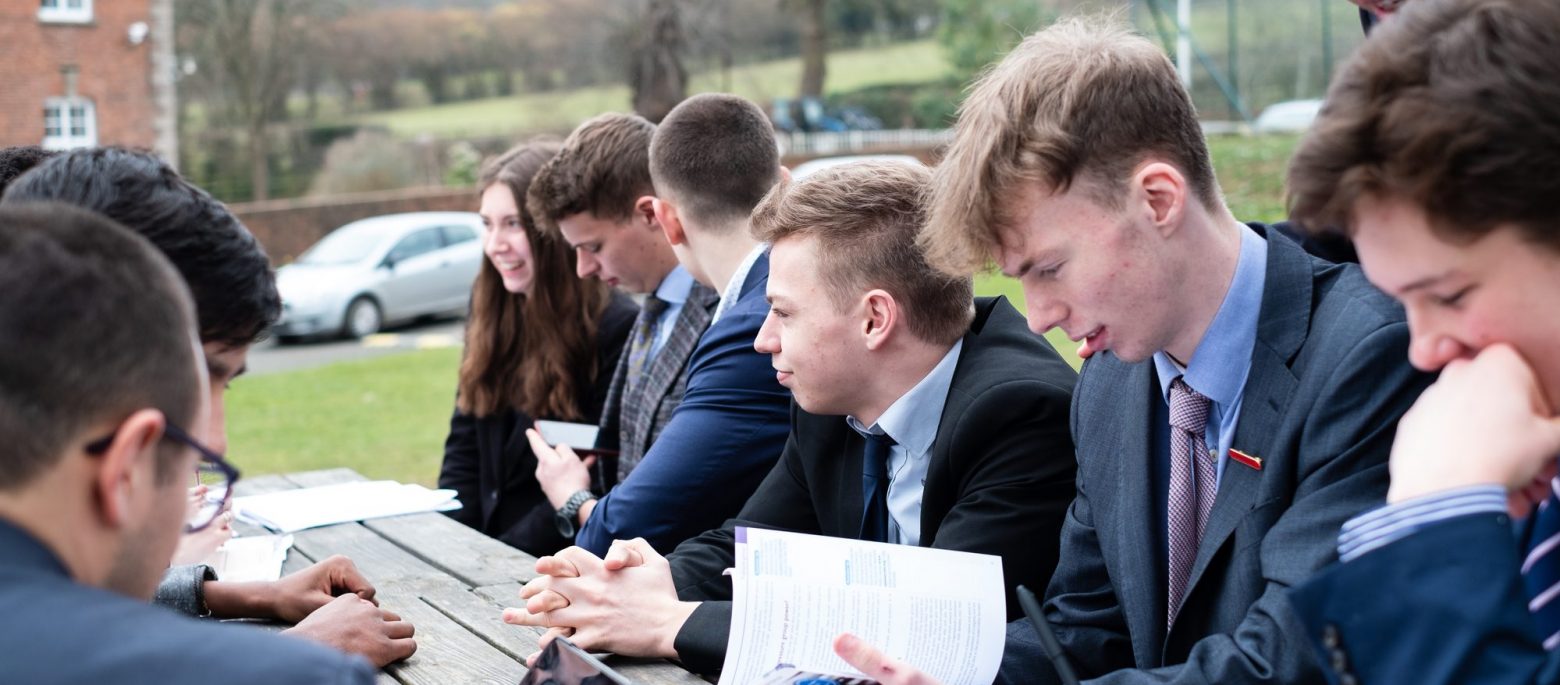 Lucton School students sitting outdoors at a picnic table