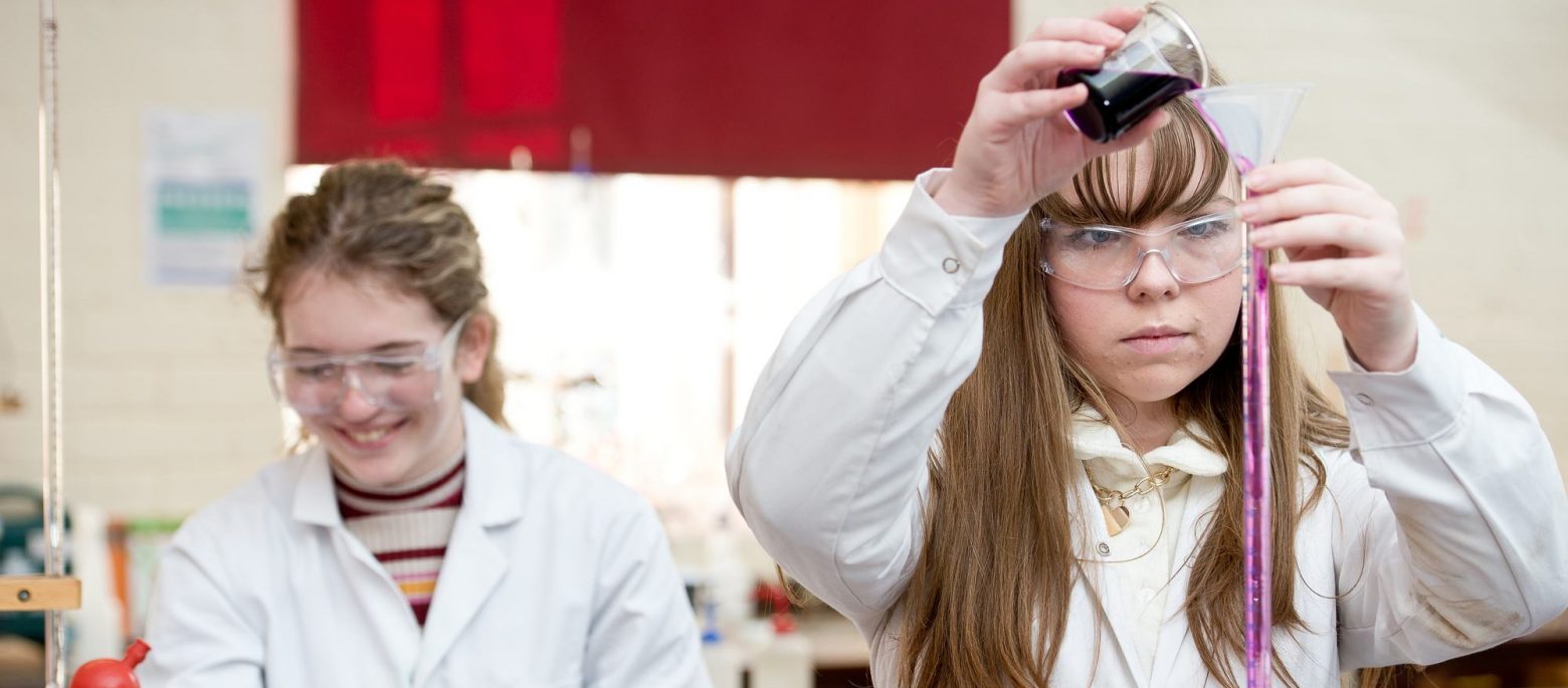 two school girls doing a science experiment