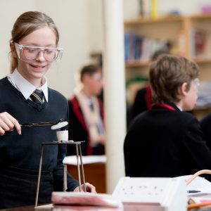 a girl using a bunsen burner