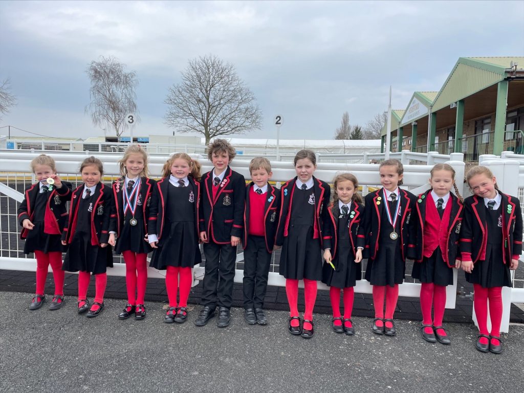 children stood outside in their school uniform