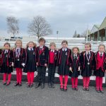 children stood outside in their school uniform