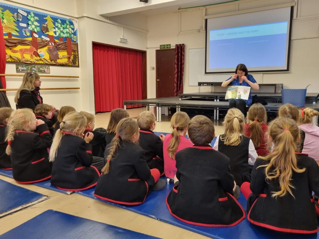 children sat in an assembly