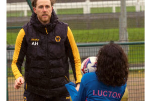Asa Hall coaching Lucton International Football Academy players during training session